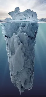 Majestic iceberg floating in calm blue ocean waters.