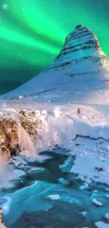 Scenic Iceland landscape with green aurora and snowy mountains.