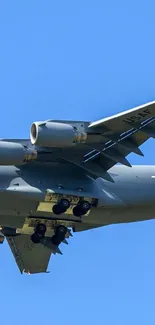 Jet airplane soaring through vibrant blue sky.