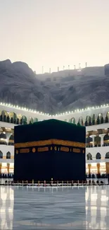 Kaaba in Mecca under the evening sky with mountaintops in the background.