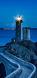 Lighthouse at dusk with a star beacon over a blue ocean.