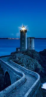 Enchanting lighthouse with ocean view at dusk, under a deep blue sky.