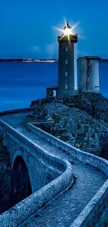 Majestic coastal lighthouse under a tranquil night sky.