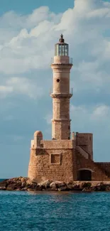 Lighthouse against a calm ocean and clear sky in a mobile wallpaper.