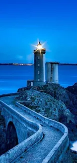 Majestic lighthouse on a coastal cliff at night.