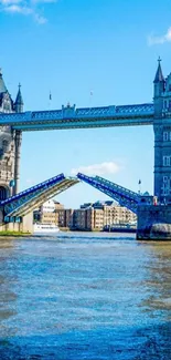 Tower Bridge in London over River Thames under a bright blue sky.