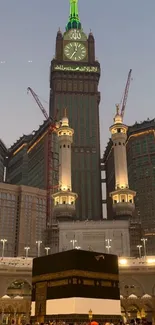 Night view of Mecca with mosque and clock tower.