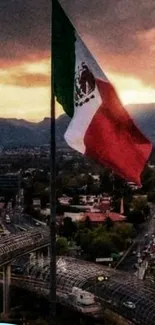 Mexican flag waving at sunset over a cityscape.