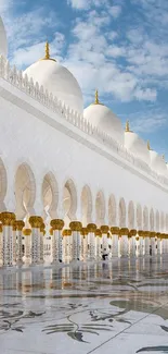 Stunning mosque architecture with white domes and elegant arches under a blue sky.