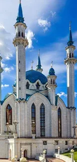 Majestic mosque with blue domes and tall minarets under a clear sky.