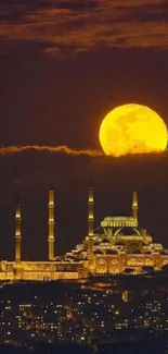 Majestic mosque under a glowing full moon at night.