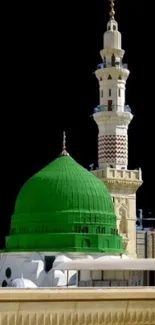 Green mosque dome with minaret and black background.