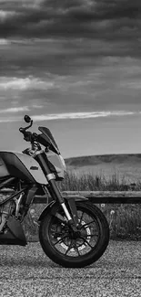 Black and white motorcycle on open road with dramatic clouds.