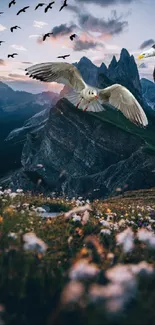 Flying birds over mountains at sunset with dark blue sky and scattered clouds.