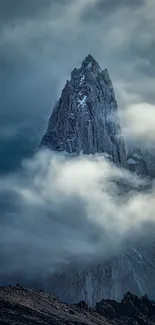 A towering mountain peak surrounded by swirling clouds creates a mystical scene.