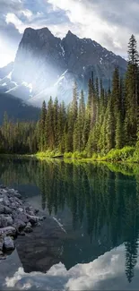 Scenic view of a mountain lake with pine trees and cloudy sky.