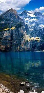 Breathtaking mountain lake with rocky peaks and clear blue water under bright skies.