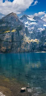 Serene mountain lake with clear blue sky and majestic peaks.