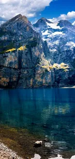 Majestic mountain lake with clear blue-green water and towering peaks.