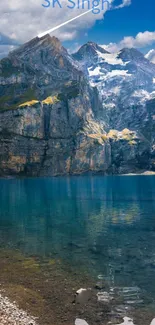 Scenic view of a mountain lake with rugged cliffs and clear blue sky.