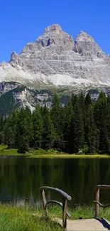 Majestic mountain reflected in a serene lake under a clear blue sky.