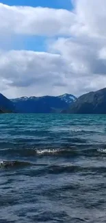 Majestic mountain lake under a cloudy sky.