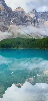 Serene mountain lake with turquoise waters, rocky peaks, and green forest reflection.