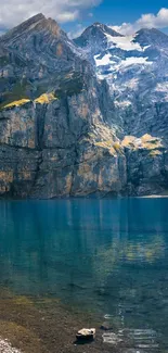 A scenic mountain lake with clear blue waters and towering rocky peaks.