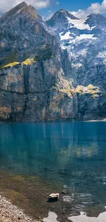 Mountain and lake wallpaper with clear blue water and rocky peaks.