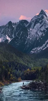 Majestic mountain landscape with river and snowy peaks at sunset.