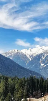 Scenic mountain landscape under a bright blue sky with lush green forests.