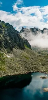 Rugged mountain peaks and serene lake under a vibrant blue sky wallpaper.