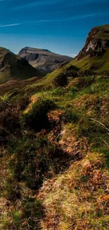 Majestic green mountain landscape under blue skies, perfect for mobile wallpaper.