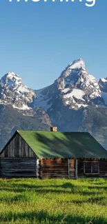 Rustic cabin with mountains and blue sky.