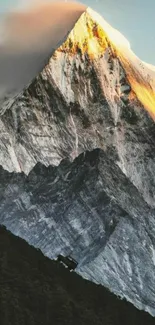 Mountain peak at sunrise with golden light and serene landscape.