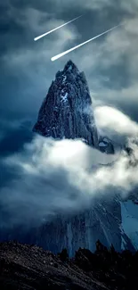 Mountain peak with clouds and shooting stars at night.