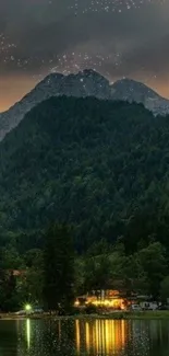 Serene mountain nightscape with lake reflection under a starry sky.