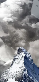 Majestic mountain peak with dramatic clouds in grayscale.