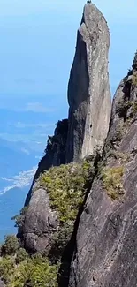 Majestic mountain peak surrounded by lush greenery.