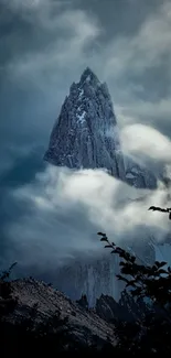 Majestic mountain peak surrounded by clouds.