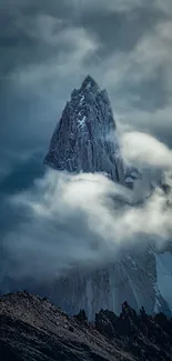 Mountain peak amidst clouds in a serene landscape.