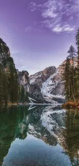 Mountain reflection in serene lake under a purple sky.