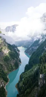 Turquoise river flowing through green mountains under a cloudy sky.