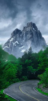 Winding road leading to a mountain under a cloudy sky in lush, green scenery.