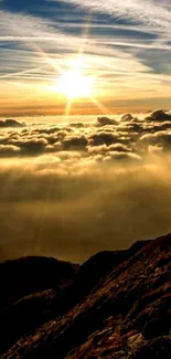 Sunrise over a mountain with clouds and golden rays.