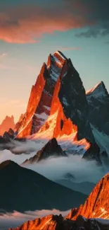 Stunning sunset-lit mountain peaks surrounded by misty clouds.