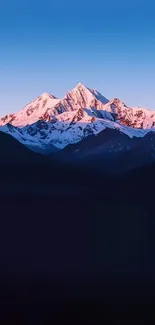 Mountain range at sunset with a serene sky.