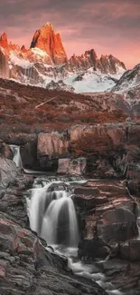 Majestic mountains at sunset with waterfalls cascading through rocky terrain.