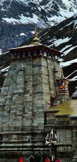 Kedarnath Temple with snowy mountain backdrop.