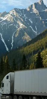 Truck driving through mountainous landscape with blue sky.